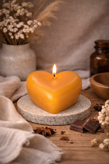 Pure beeswax heart candle with honey and chocolate fudge scent styled on a stone tray with linen and warm decor