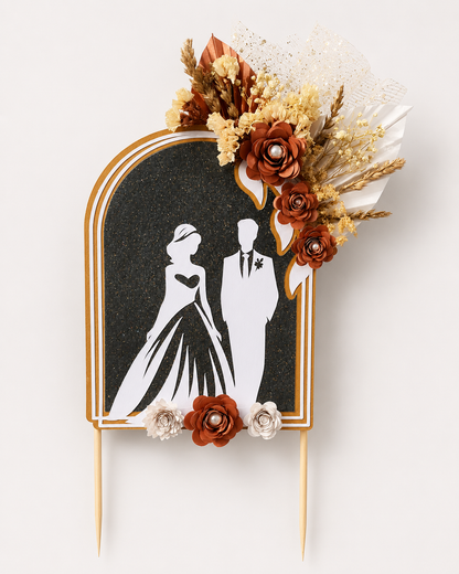 Large handmade wedding cake topper with dried florals and bride and groom silhouette